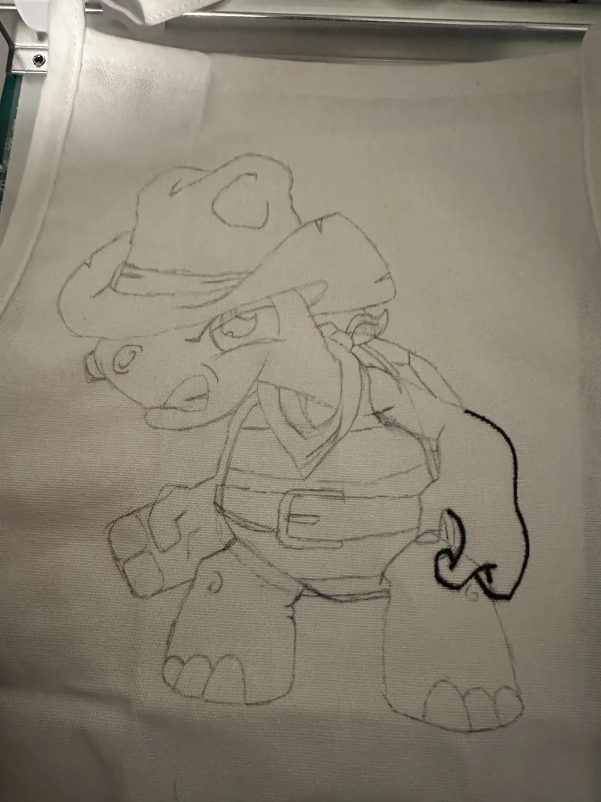 The turtle sketched in pencil on the apron before painting