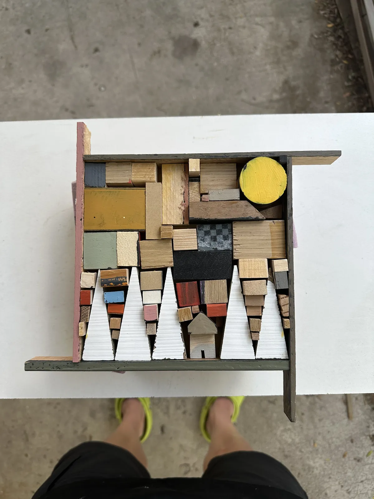 The piece in raw wood scraps before painting