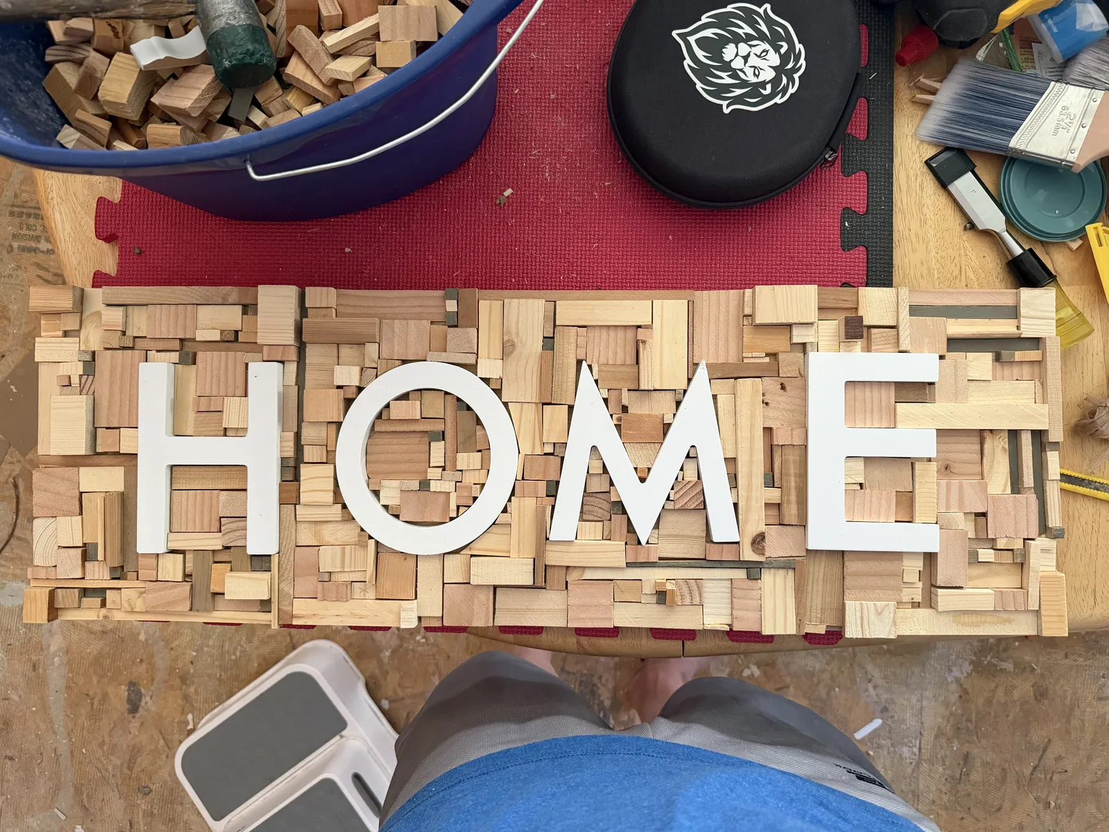 The HOME sign in raw wood scraps before painting