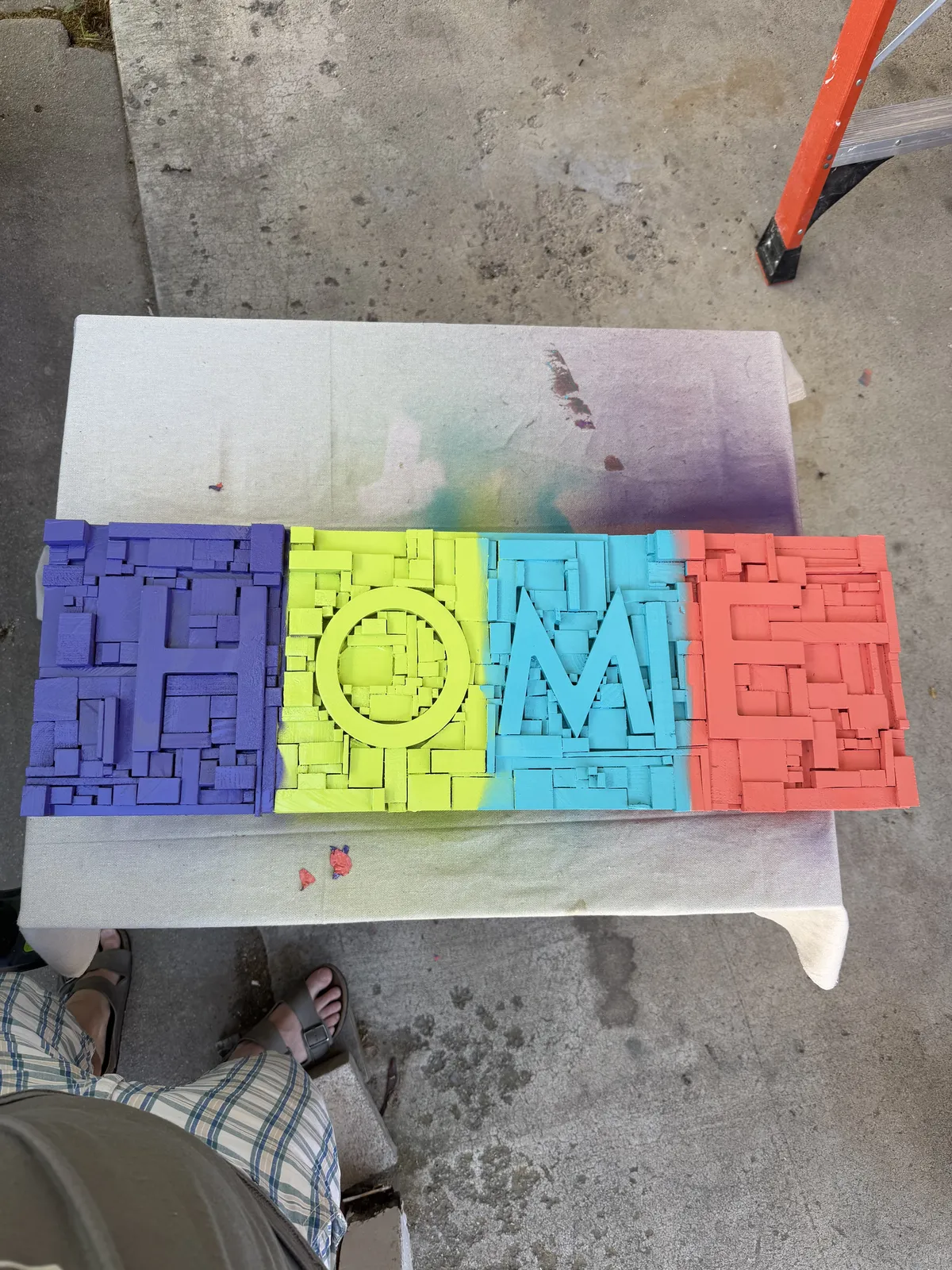 The HOME sign after the base colors were sprayed on