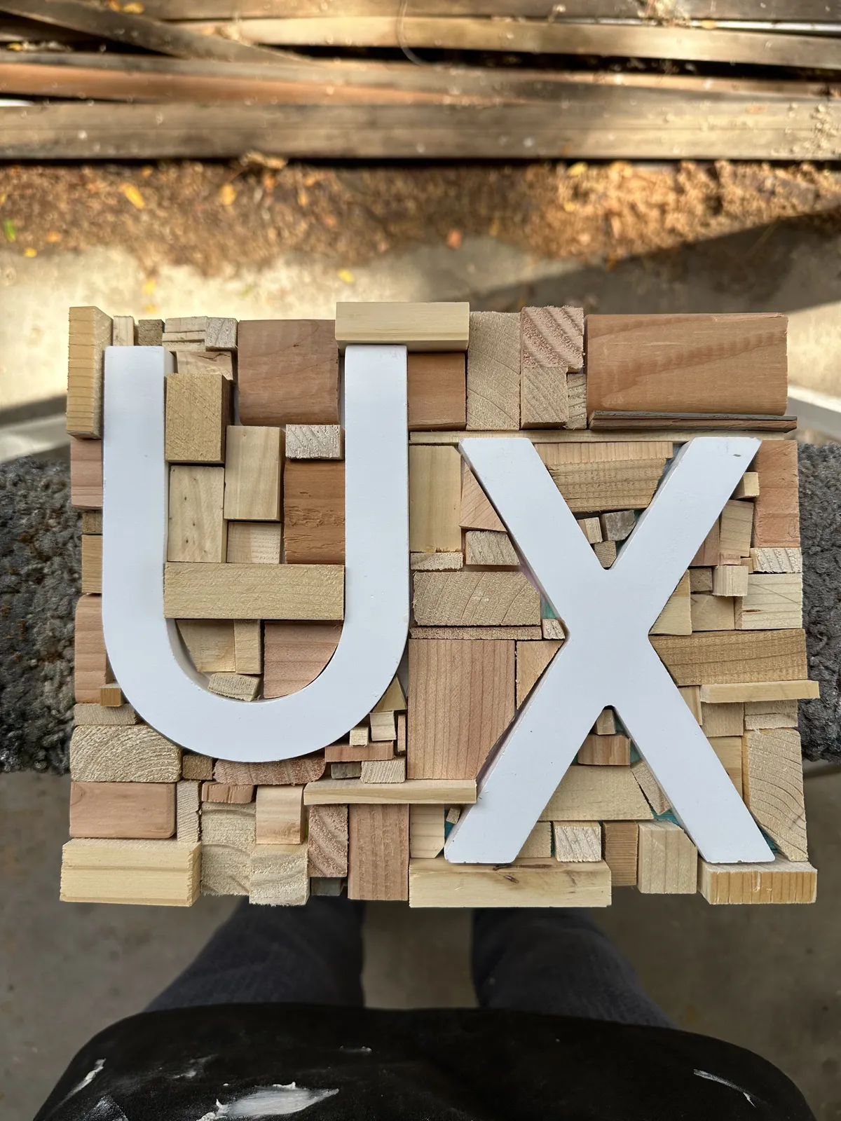 The UX sign in raw wood before painting